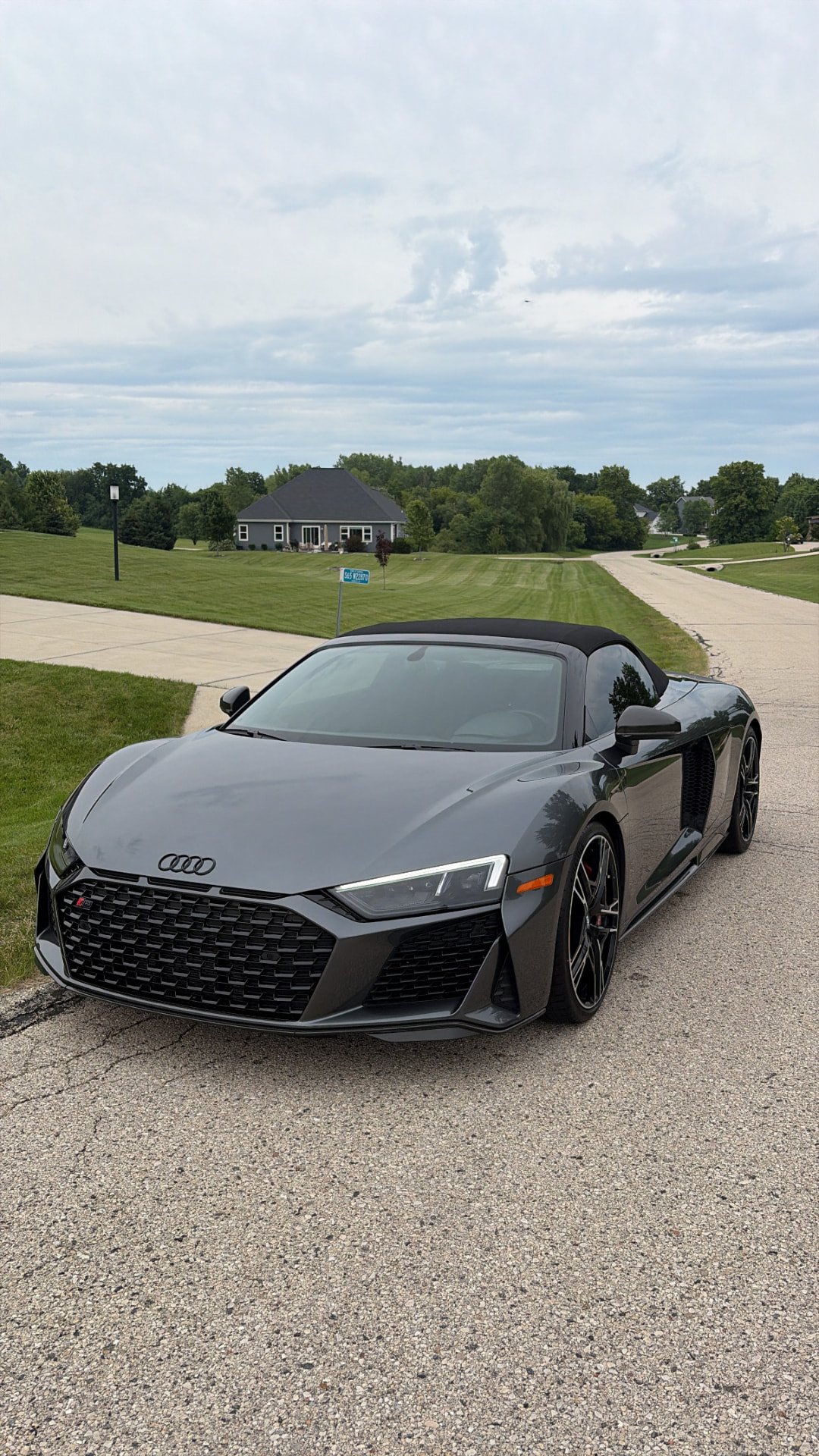 Freshly detailed grey Audi R8 Spyder in a Waukesha driveway