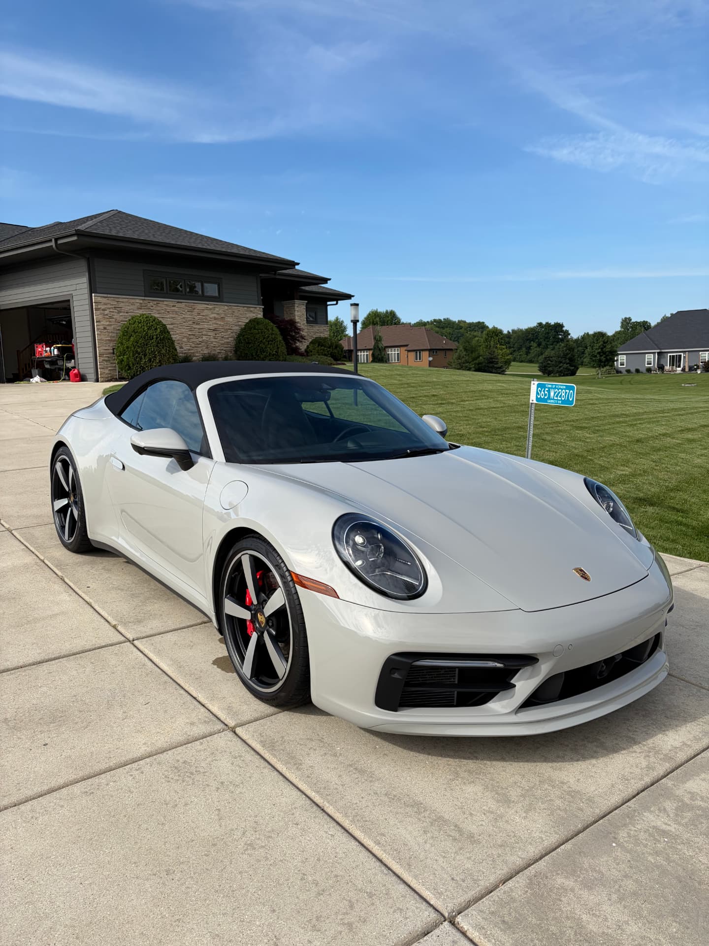 Freshly detailed chalk Porsche 911 Cabriolet on a Wisconsin driveway