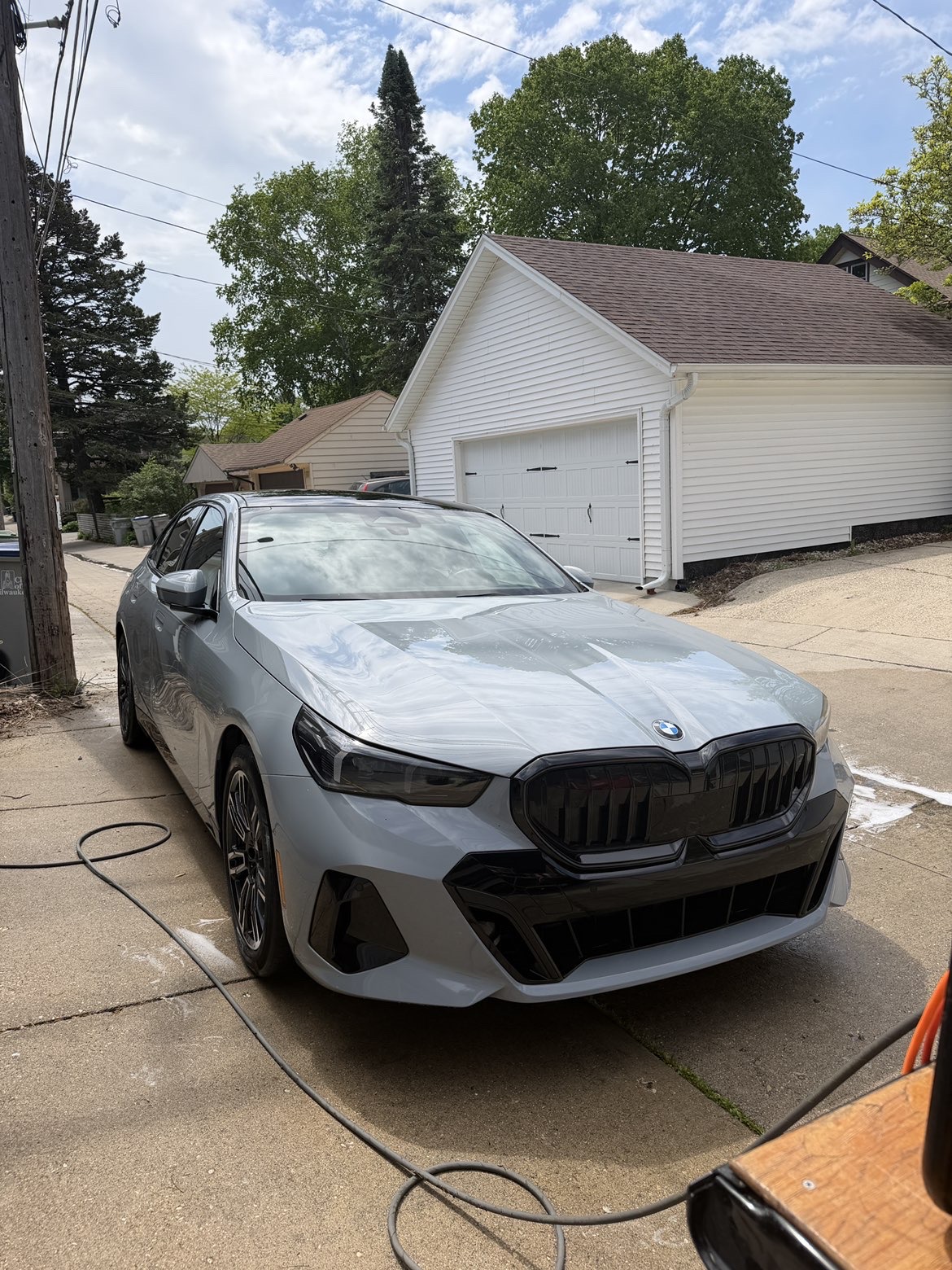 Freshly detailed grey BMW 5 Series on a driveway