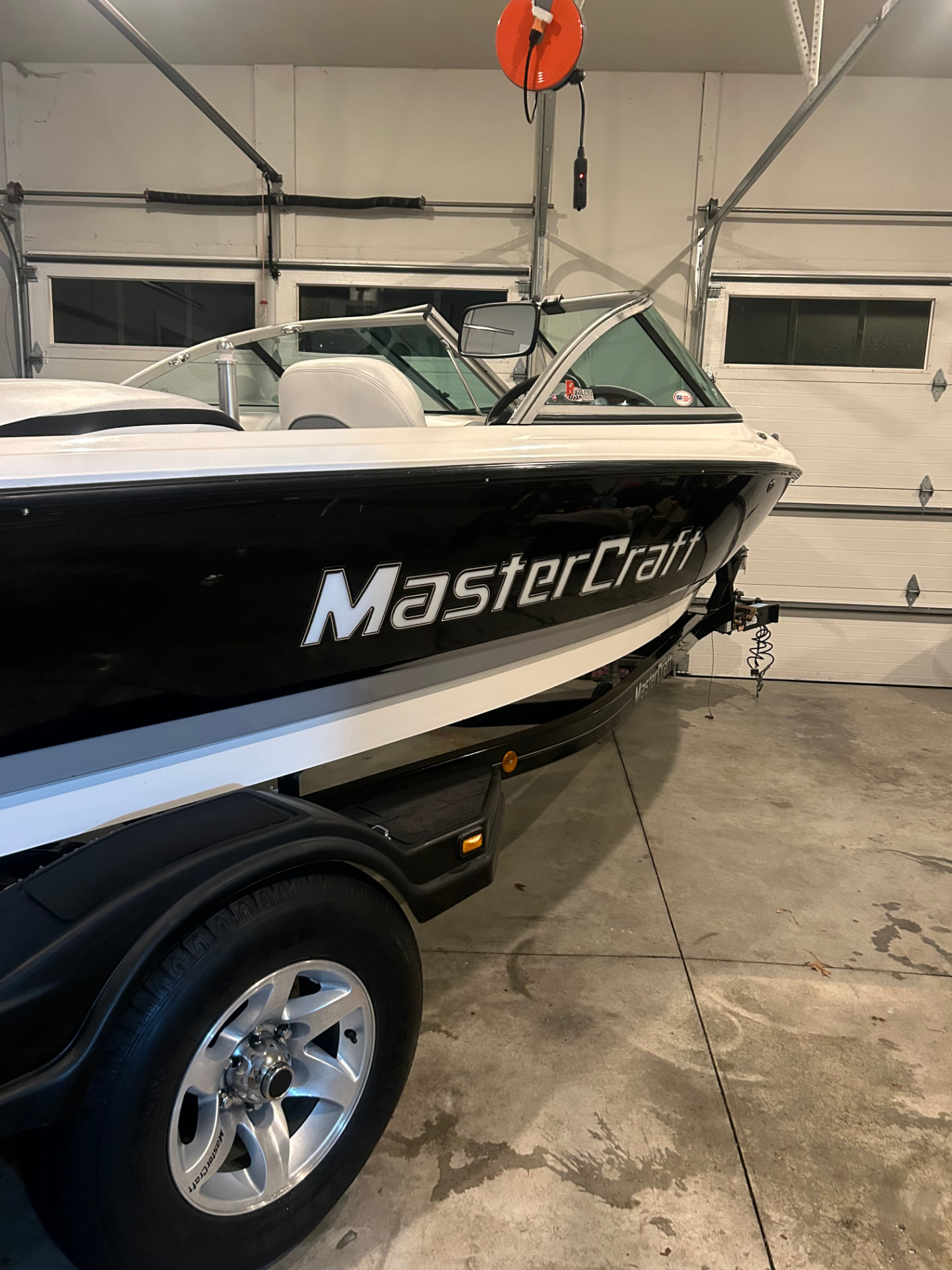 Freshly detailed black MasterCraft boat on a trailer