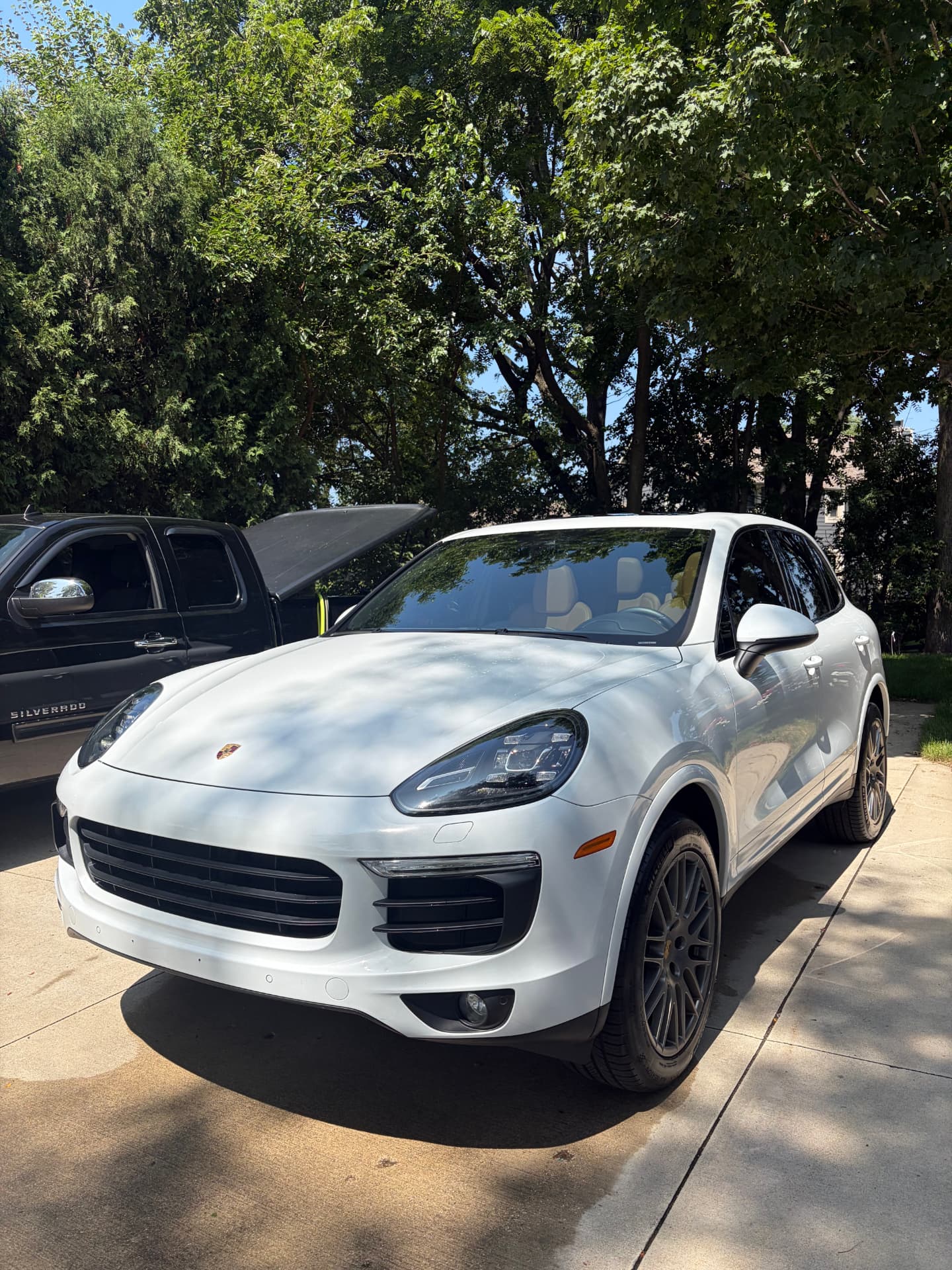 Freshly detailed white Porsche Cayenne on a driveway